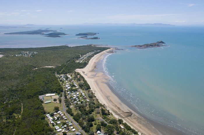Seaforth Pines on the lower left with the Red Cliffs Island Reef on upper right and the islands of nearby Newry Islands National Park at upper left.